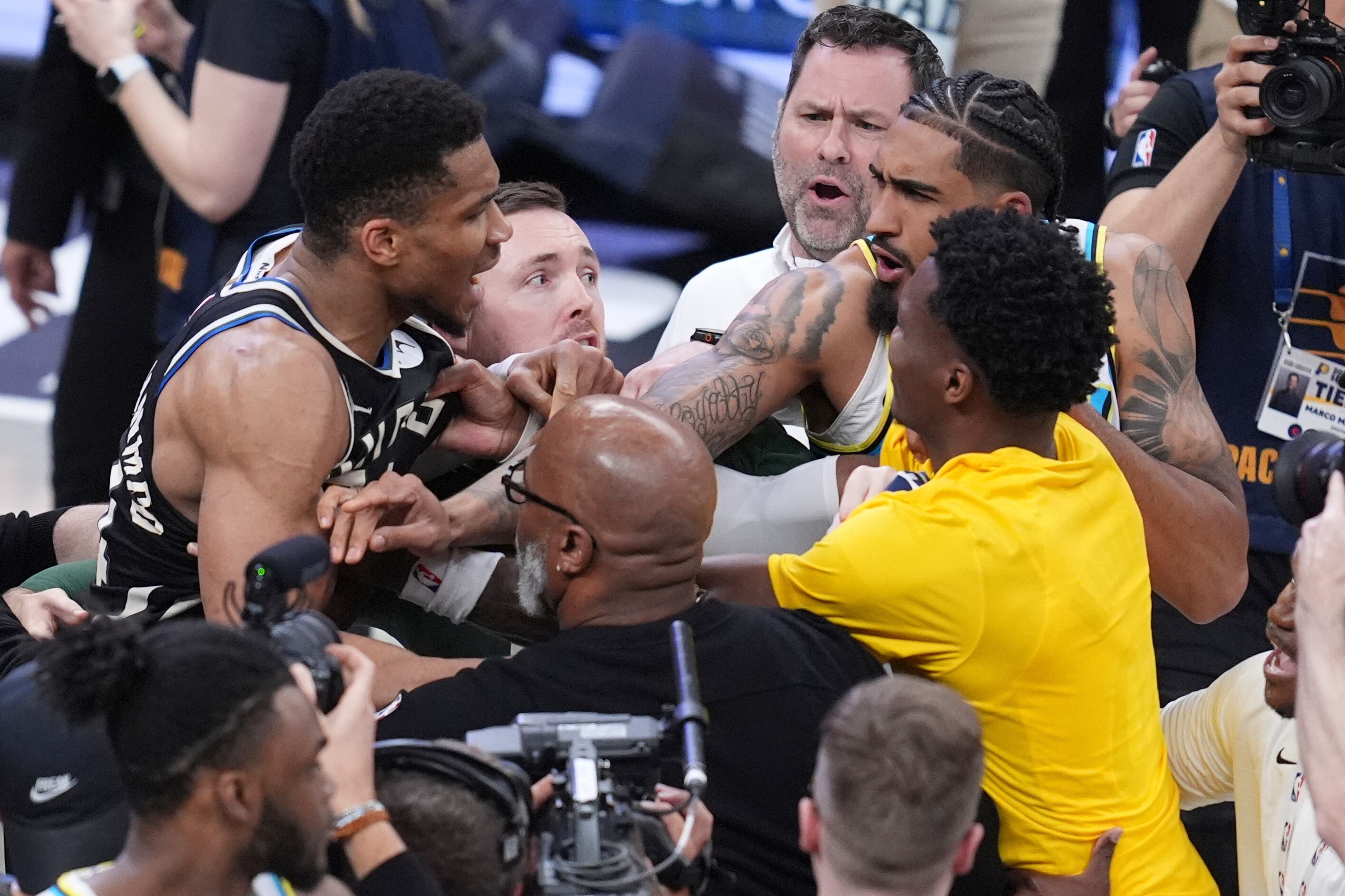 Milwaukee Bucks forward Giannis Antetokounmpo, left, is separated from Indiana Pacers players forward Obi Toppin, second from right, and guard Bennedict Mathurin, right, after Game 5 of an NBA basketball first-round playoff series in Indianapolis, Tuesday, April 29, 2025. (AP Photo/Michael Conroy)