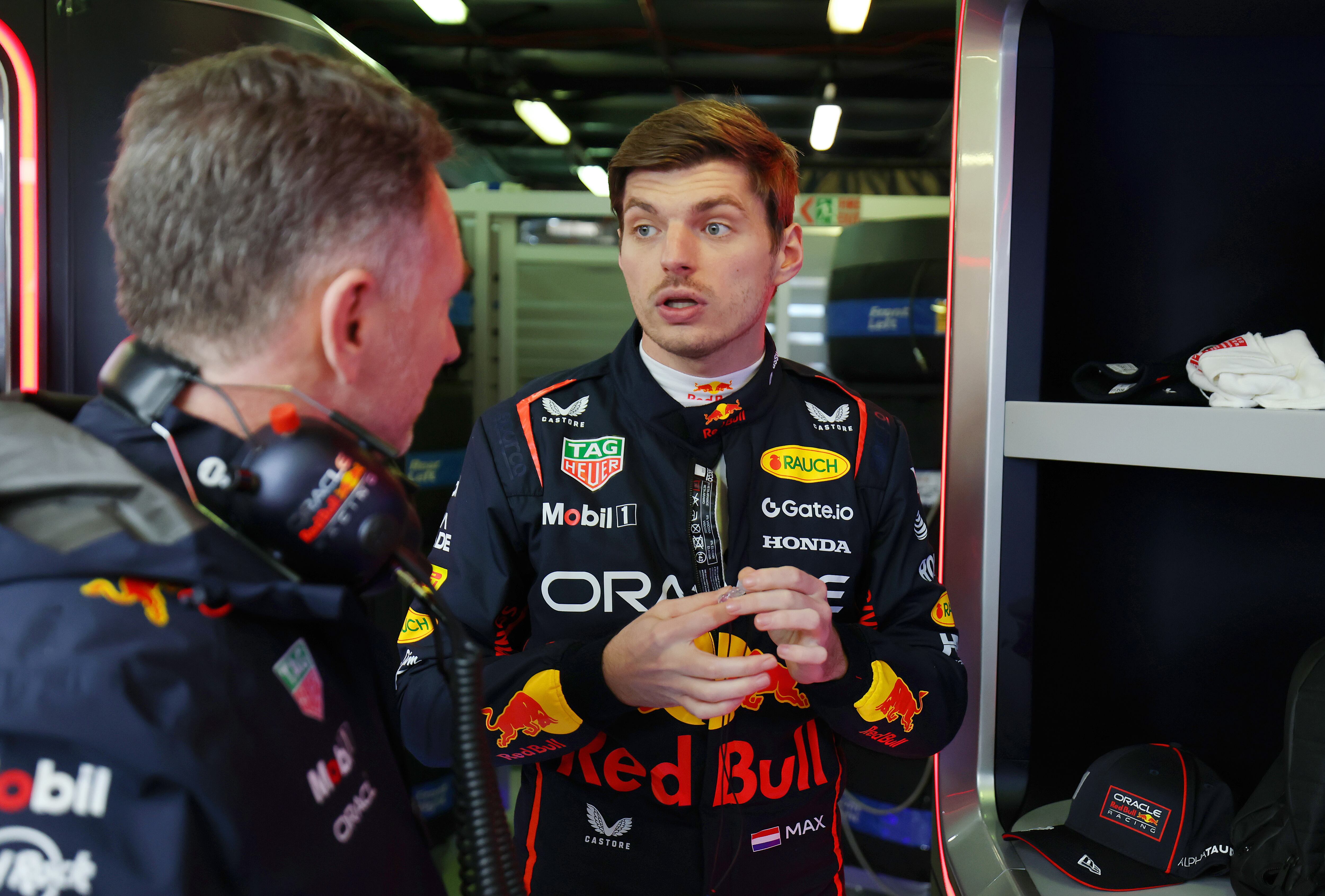 MELBOURNE, AUSTRALIA - MARCH 16: Christian Horner, Team Principal of Oracle Red Bull Racing talks with Max Verstappen of the Netherlands and Oracle Red Bull Racing in the garage prior to the F1 Grand Prix of Australia at Albert Park Grand Prix Circuit on March 16, 2025 in Melbourne, Australia. (Photo by Mark Thompson/Getty Images)
