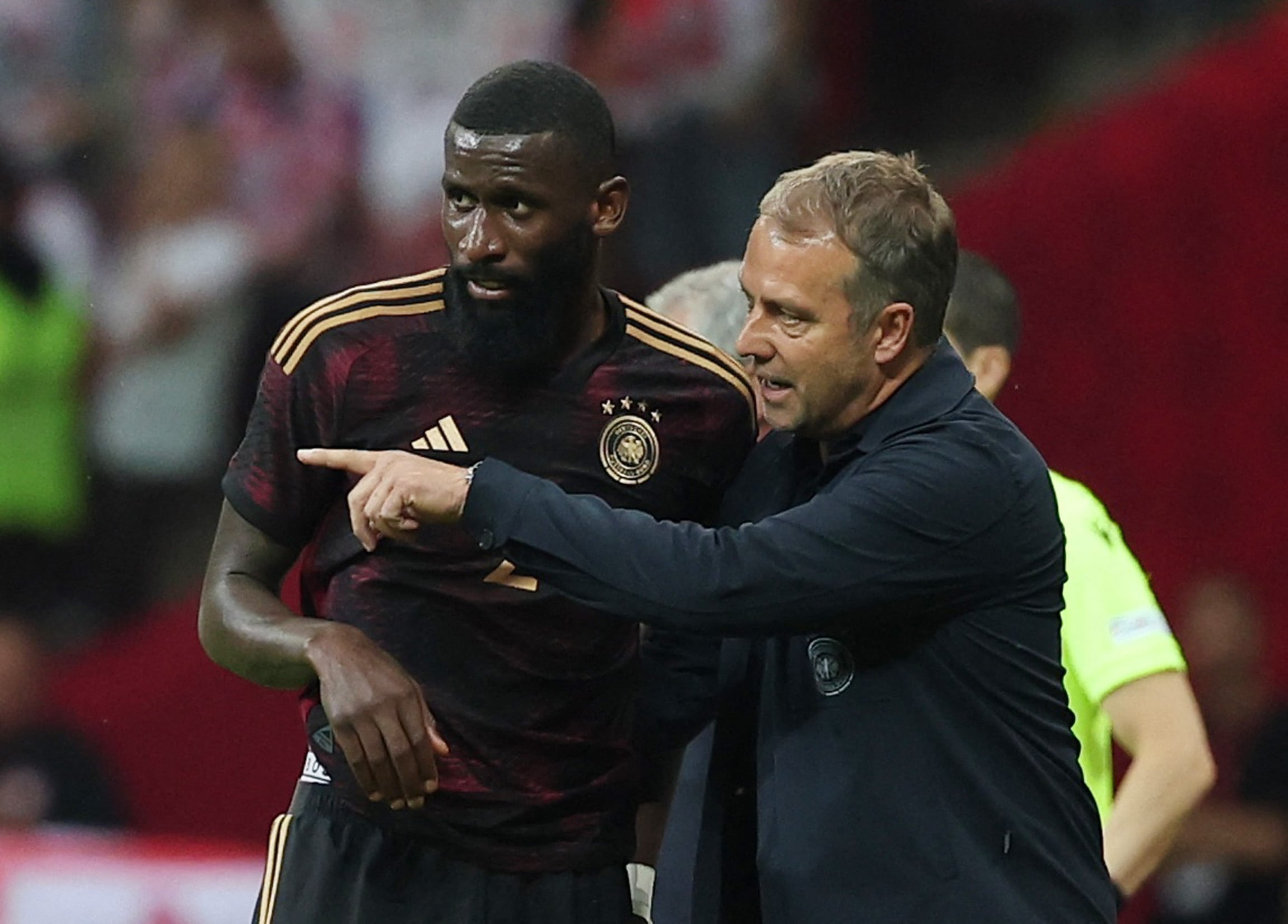 Soccer Football - International Friendly - Poland v Germany - Stadion Narodowy, Warsaw, Poland - June 16, 2023  Germany coach Hansi Flick speaks to Antonio Rüdiger REUTERS/Kacper Pempel
