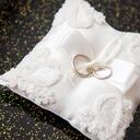 two wedding rings on a pillow