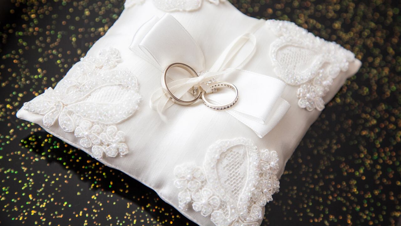 two wedding rings on a pillow