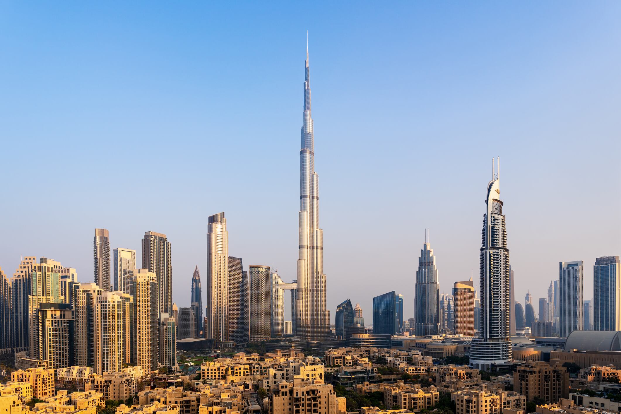 The sun rises over Dubai, casting a warm glow on the citys impressive skyline.