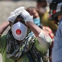 A relative of a person who died of COVID-19 reacts at a crematorium in Jammu, India, Sunday, April.25, 2021. (AP Photo/Channi Anand)