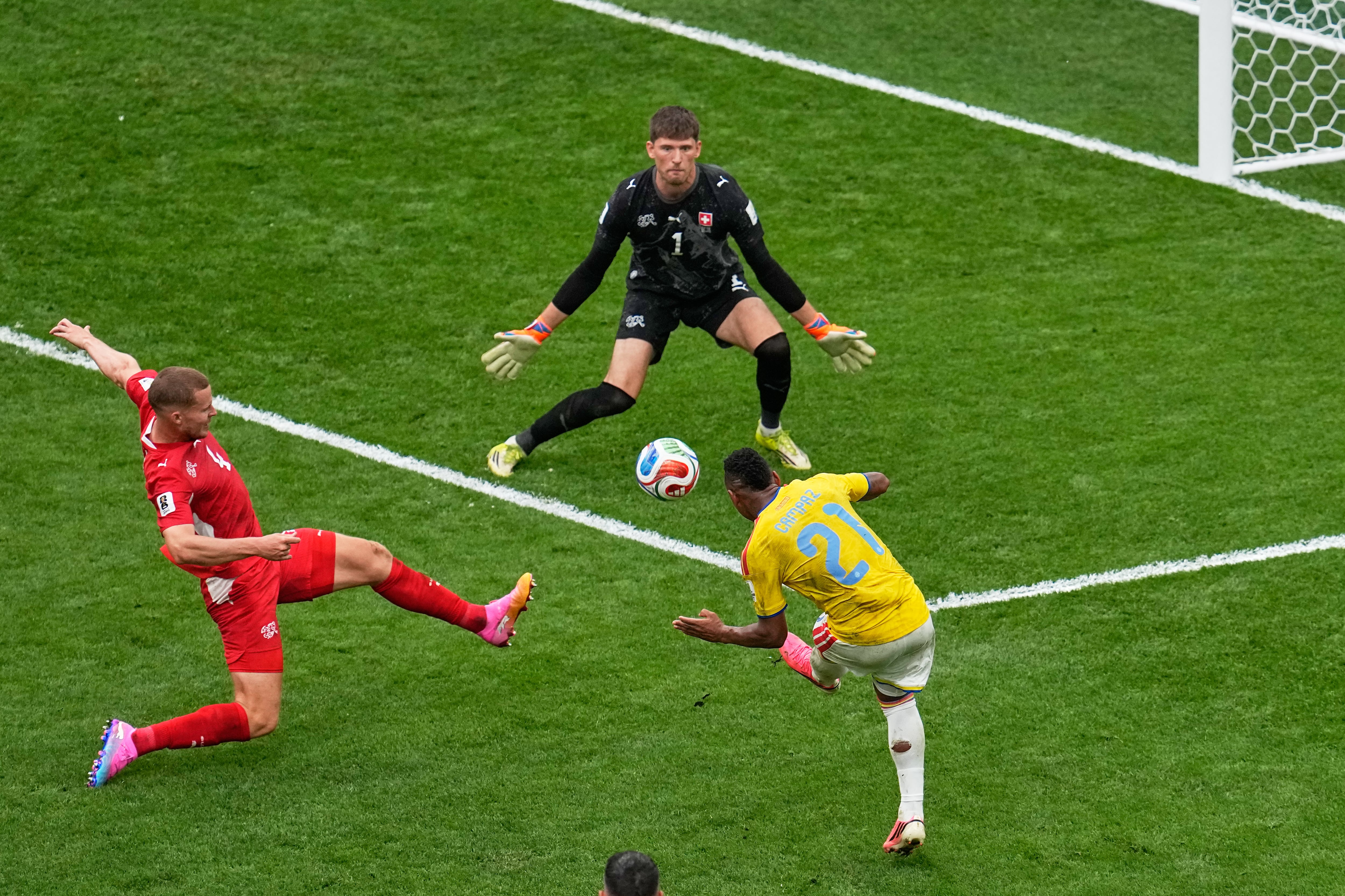 Colombia's Jaminton Campaz (21) misses a shot on goal as Switzerland goalkeeper Gregor Kobel (1) defends during the World Cup round of 16 soccer match in Vancouver, British Columbia, Tuesday, July 7, 2026. (AP Photo/Gregory Bull)