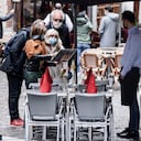 A waiter waits for customers on a terrace in Brussels on May 8, 2021, as the Belgium government eased the restrictions put in place to curb the spread of the coronavirus, Covid-19. (Photo by Kenzo TRIBOUILLARD / AFP)