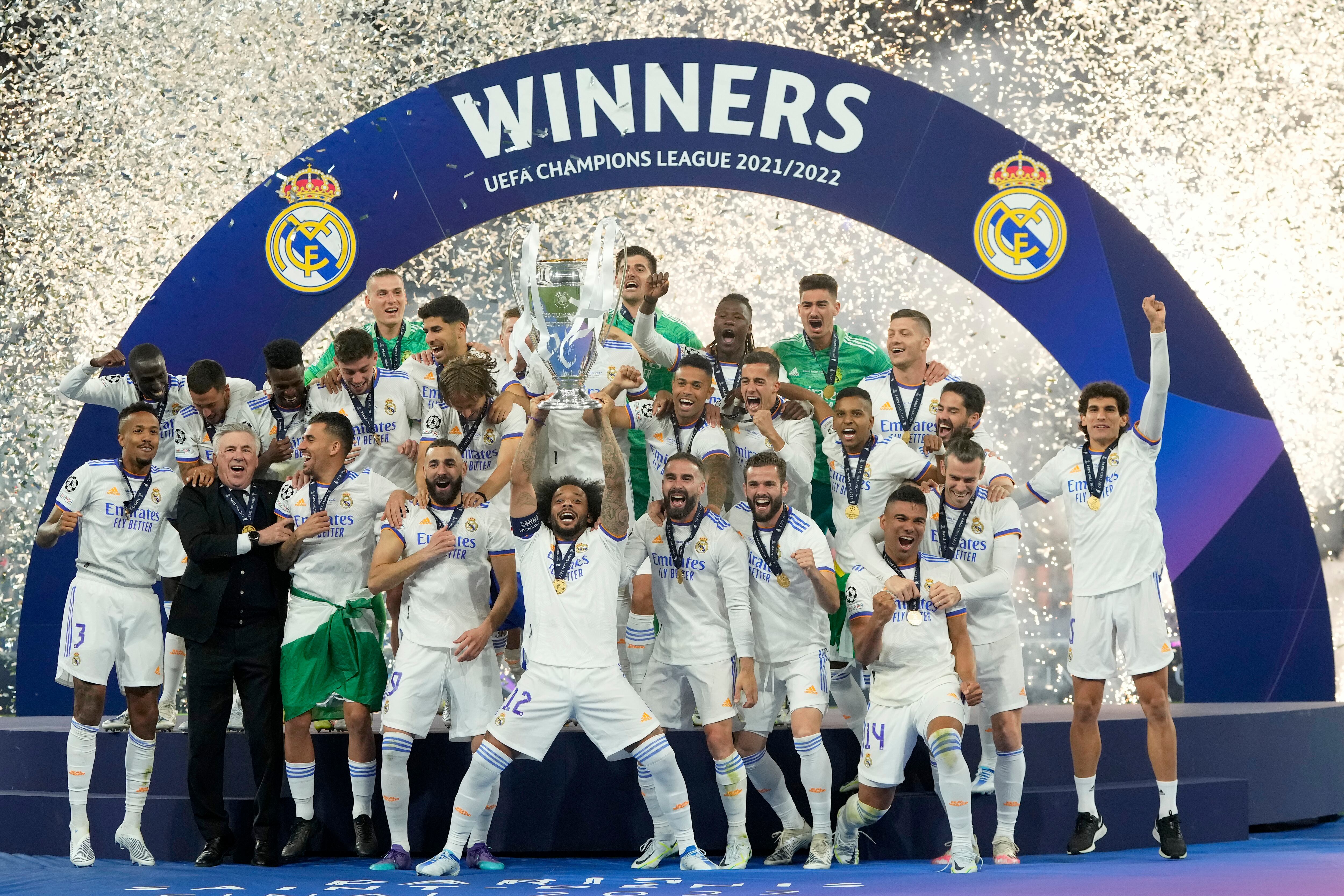 Real Madrid's Marcelo lifts the trophy after winning the Champions League final soccer match between Liverpool and Real Madrid at the Stade de France in Saint Denis near Paris, Saturday, May 28, 2022. Real Madrid defeated Liverpool 1-0.(AP Photo/Manu Fernandez)