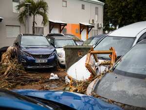 This photograph taken on September 18, 2022, shows debris and cars swept away and overlapping each other after the passage of Hurricane Fiona in Goyave, on the French island of Guadeloupe. (Photo by Carla Bernhardt / AFP)