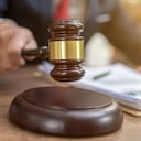 Close up lawyer businessman working or reading lawbook in office workplace for consultant lawyer concept.