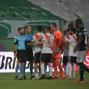 Player of Palmeiras celebrate as River Plate's players complain with the referee at the end of a Copa Libertadores semifinal second leg soccer match at the Allianz Parque stadium in Sao Paulo, Brazil, Tuesday, Jan. 12, 2021. Palmeiras won 3-2 on aggregate and advanced to the final.(Nelson Almeida/Pool via AP)