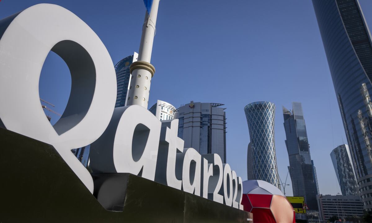 FILE - Branding is displayed near the Doha Exhibition and Convention Center in Doha, Qatar, Thursday, March 31, 2022. Qatar’s ruling emir has lashed out at criticism of the country over its hosting of the 2022 FIFA World Cup, complaining of an “unprecedented campaign” targeting the first Arab nation to hold the tournament. (AP/Darko Bandic, File)