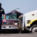 Law enforcement officers work at the scene of a deadly crash in Holtville, Calif., on Tuesday, March 2, 2021. Authorities say a semi-truck crashed into an SUV carrying multiple people on a Southern California highway, killing at least 13 people and injuring others. (AP Photo/Gregory Bull)