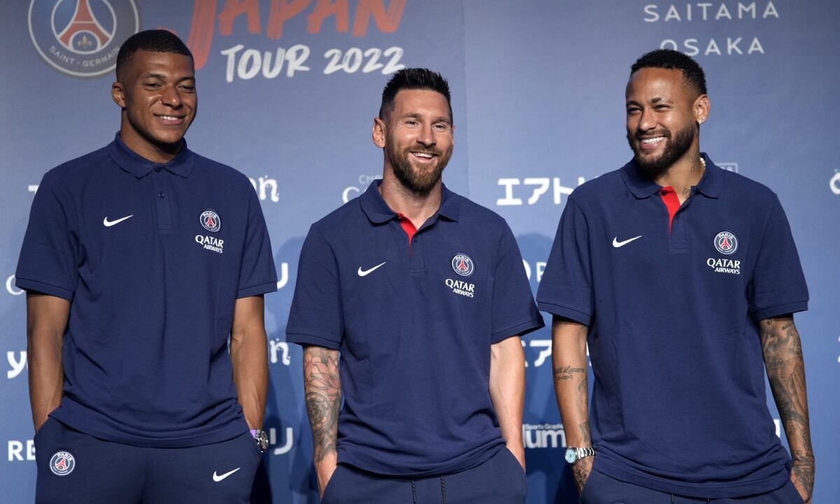 CORRECTS DATE - Paris Saint-Germain soccer players, Kylian Mbappe, left, Lionel Messi, center, and Neymar pose for photographers during a press conference in Tokyo Sunday, July 17, 2022. Paris Saint-Germain is in Japan for their pre-season tour.(AP/Shuji Kajiyama)