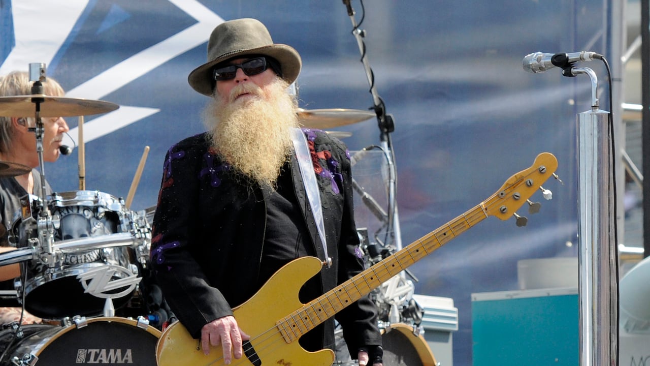 FILE - Dusty Hill, of ZZ Top, performs before the start of the NASCAR Sprint Cup series auto race in Concord, N.C., May 24, 2015. ZZ Top has announced that Hill, one of the Texas blues trio's bearded figures and bassist, has died at his Houston home. He was 72. In a Facebook post, bandmates Billy Gibbons and Frank Beard revealed Wednesday, July 29, 2021, that Hill had died in his sleep. (AP Photo/Mike McCarn, File)