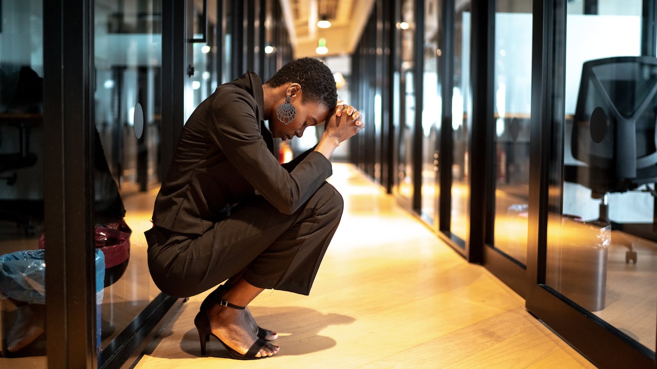 Worried young businesswoman at corridor office