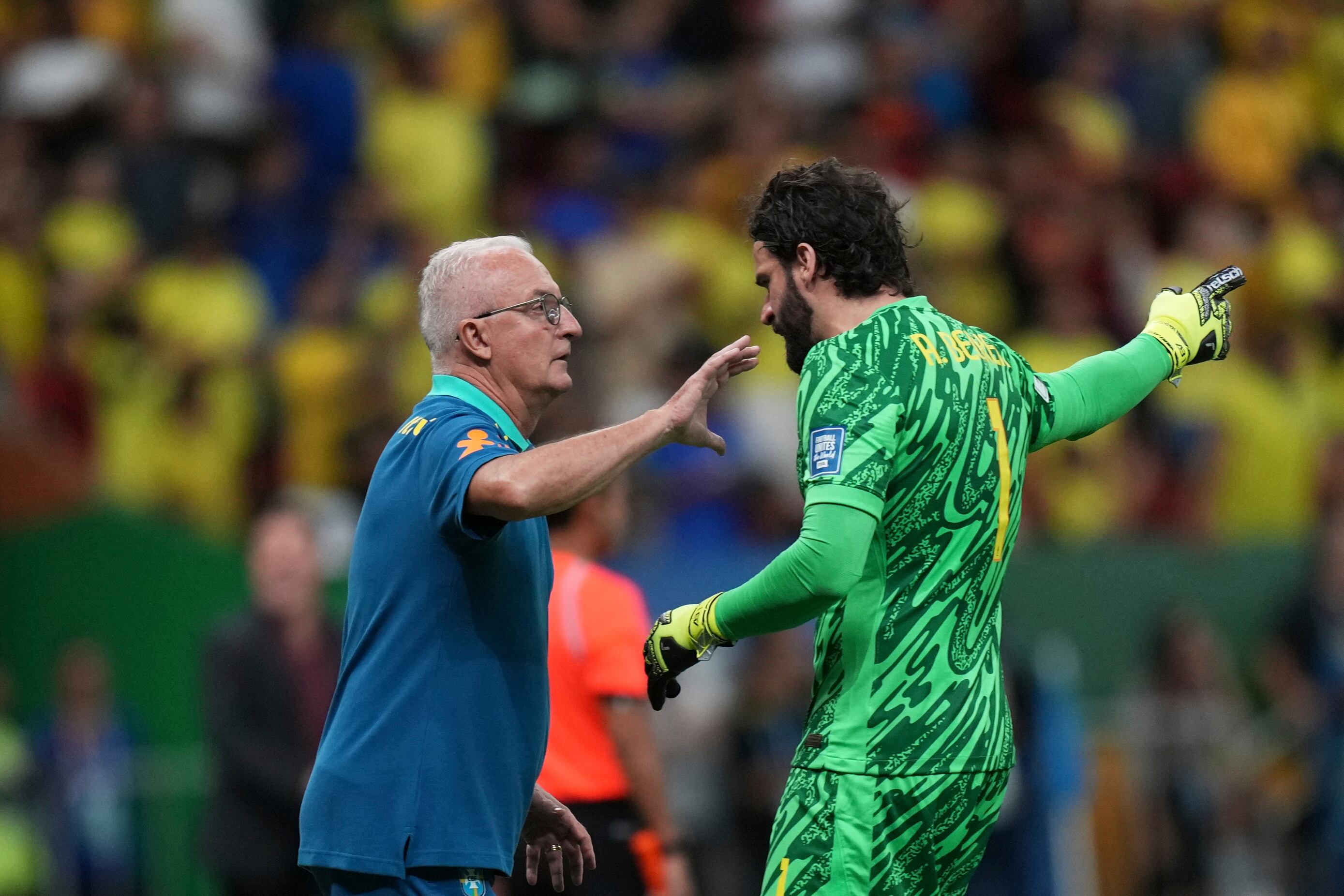 Brazil's coach Dorival Junior gives instructions to Brazil's goalkeeper Alisson during a FIFA World Cup 2026 qualifying soccer match against Colombia at Mane Garrincha stadium in Brasilia, Brazil, Thursday, March 20, 2025. (AP Photo/Silvia Izquierdo)