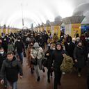 Personas, algunas con bolsas y maletas, caminan en una estación de metro en Kiev a primera hora del 24 de febrero de 2022. - El presidente ruso, Vladimir Putin, anunció el jueves una operación militar en Ucrania con explosiones que se escucharon poco después en todo el país y su ministro de Relaciones Exteriores advirtió un " invasión a gran escala" estaba en marcha.(Photo by Daniel LEAL / AFP)