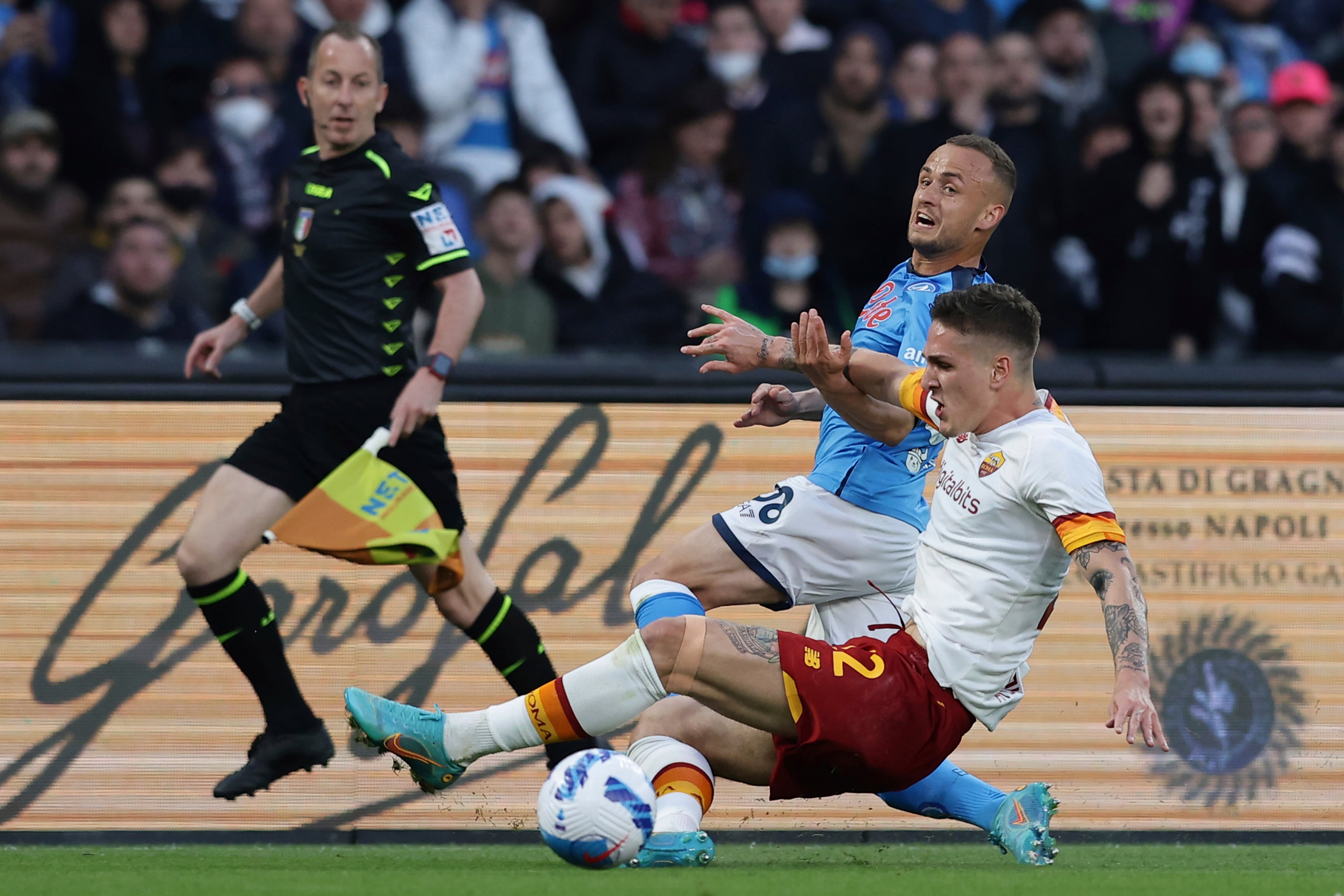Napoli's Stanislav Lobotk and Roma's Nicolo Zaniolo, right, avie for the ball during the Serie A soccer match between Napoli and Roma, at the Diego Armando Maradona stadium in Naples, Monday, April 18, 2022. (Alessandro Garofalo/LaPresse via AP)