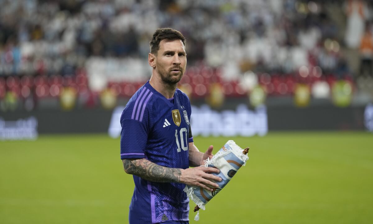 Argentina's Lionel Messi walks on the pitch before a friendly soccer match between Argentina and United Arab Emirates in Abu Dhabi, Wednesday, Nov. 16, 2022. (AP/Kamran Jebreili)