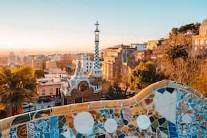 View of the city from Park Guell in Barcelona, Spain with sunrise colors.