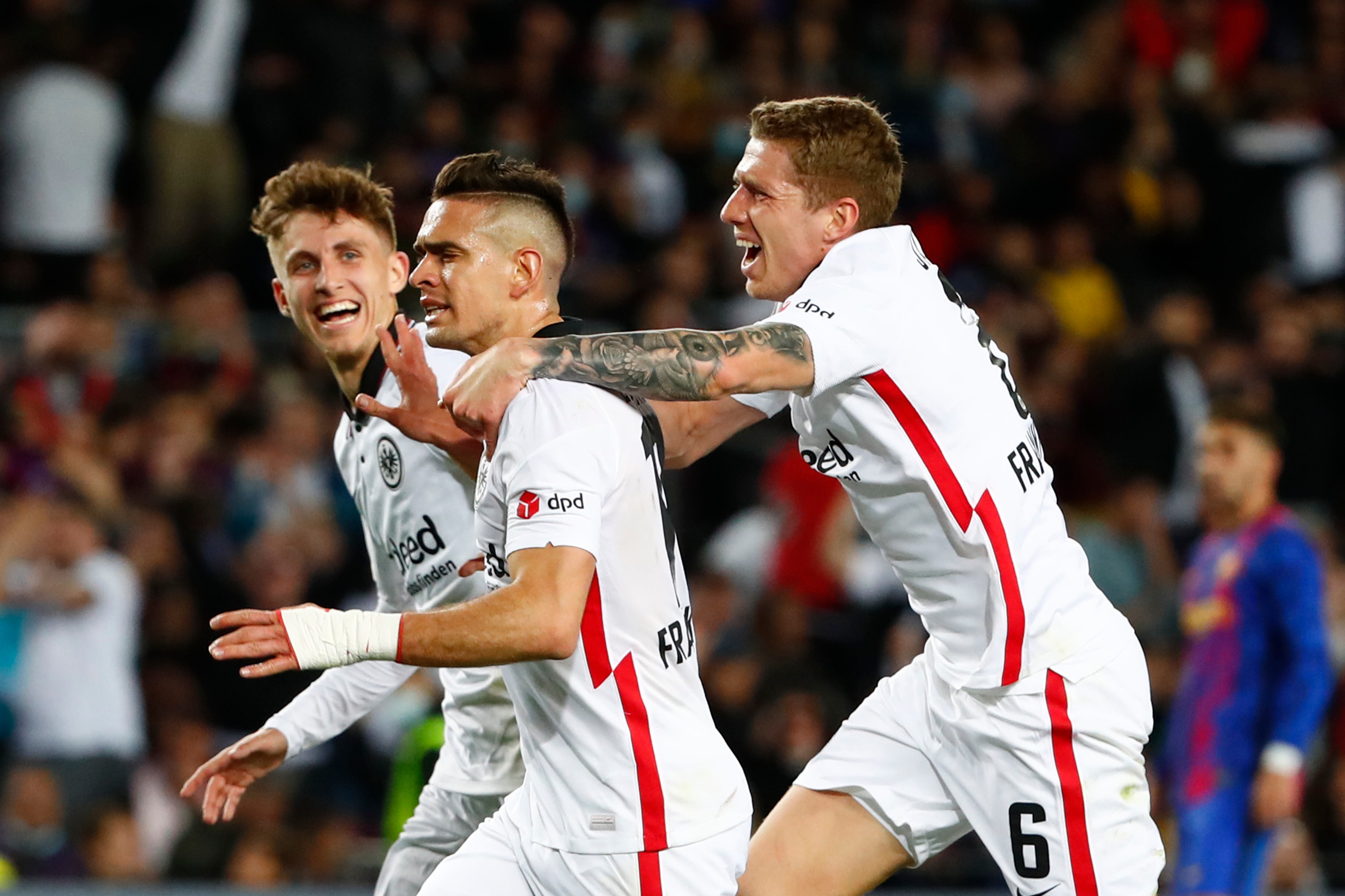 Frankfurt's Rafael Santos Borre, center, celebrates after scoring his side's second goal during the Europa League, second leg, quarterfinal soccer match between Barcelona and Eintracht Frankfurt at the Camp Nou stadium, in Barcelona, Spain, Thursday, April 14, 2022. (AP Photo/Joan Monfort)