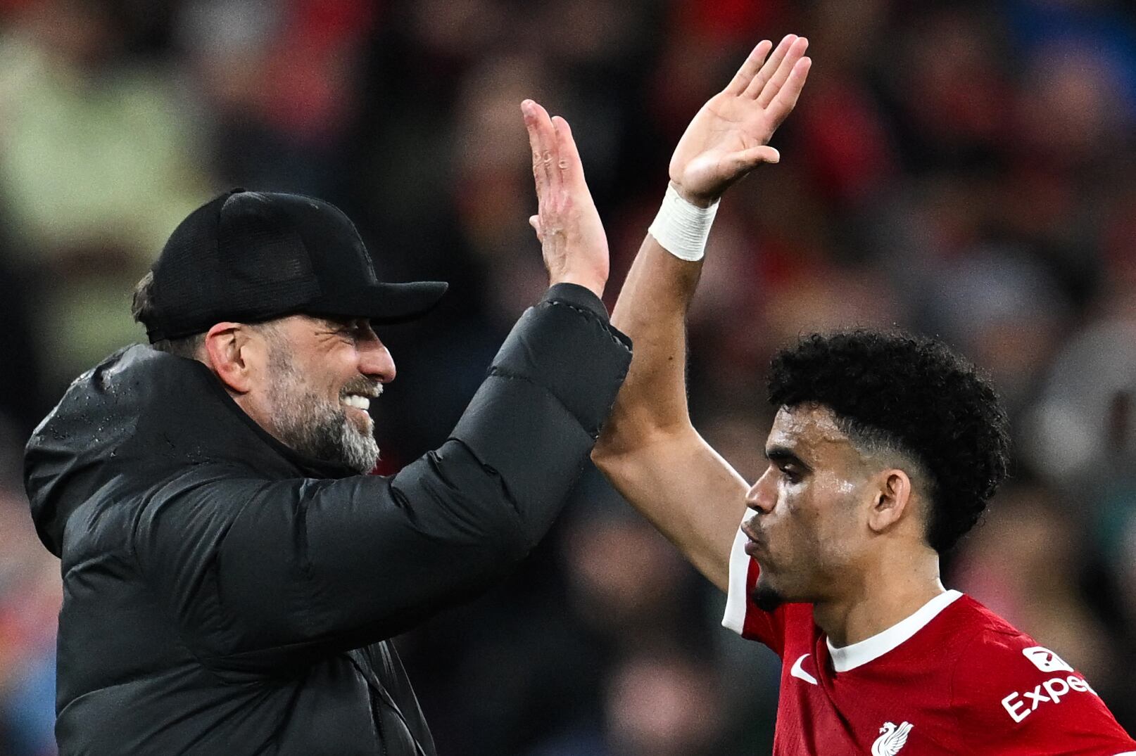 Liverpool's German manager Jurgen Klopp (L) celebrates with Liverpool's Colombian midfielder #07 Luis Diaz at the end of the English Premier League football match between Liverpool and Sheffield United at Anfield in Liverpool, north west England on April 4, 2024. Liverpool wins 3 - 1 against Sheffield United. (Photo by Paul ELLIS / AFP) / RESTRICTED TO EDITORIAL USE. No use with unauthorized audio, video, data, fixture lists, club/league logos or 'live' services. Online in-match use limited to 120 images. An additional 40 images may be used in extra time. No video emulation. Social media in-match use limited to 120 images. An additional 40 images may be used in extra time. No use in betting publications, games or single club/league/player publications. /