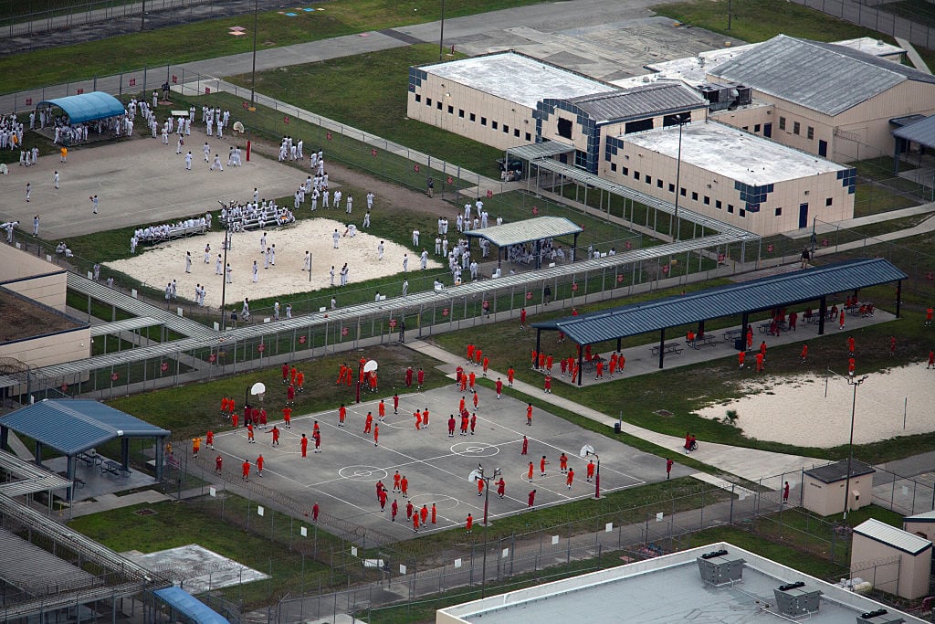 MIAMI, FLORIDA - JULY 4: In an aerial view from a helicopter, detainees are seen at Krome Detention Center run by United States Immigration and Customs Enforcement on July 4, 2025 in Miami, Florida. U.S. President Donald Trump was present at the opening of the nearby "Alligator Alcatraz", a 5,000-bed facility, located at an abandoned airfield in the Everglades wetlands, part of his expansion of undocumented migrant deportations. (Photo by Alon Skuy/Getty Images)