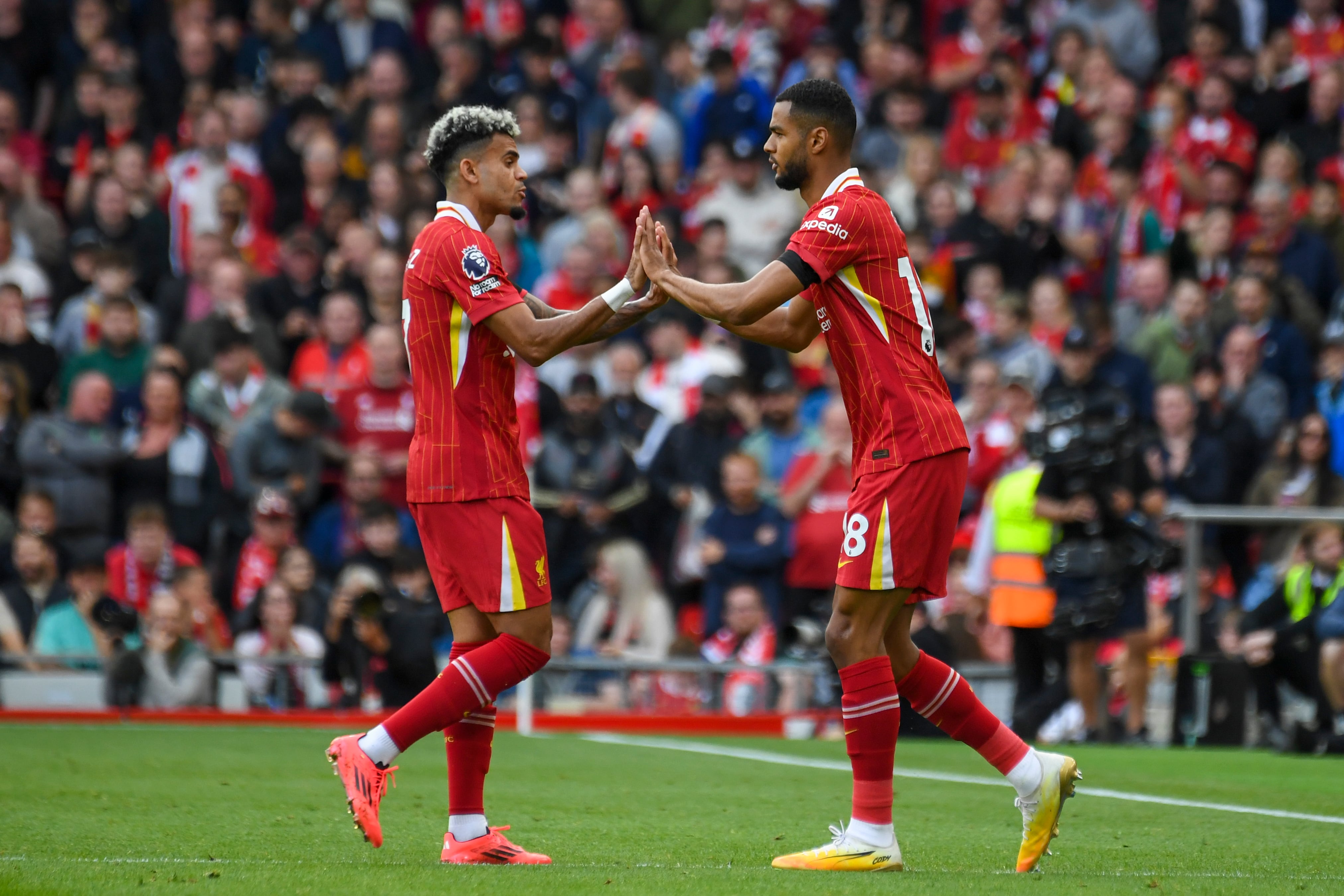 Liverpool's Luis Diaz, left, shakes hands with Cody Gakpo after being substituted during the English Premier League soccer match between Liverpool and Nottingham Forest at Anfield Stadium in Liverpool, England, Saturday, Sept. 14, 2024. (AP Photo/Rui Vieira)