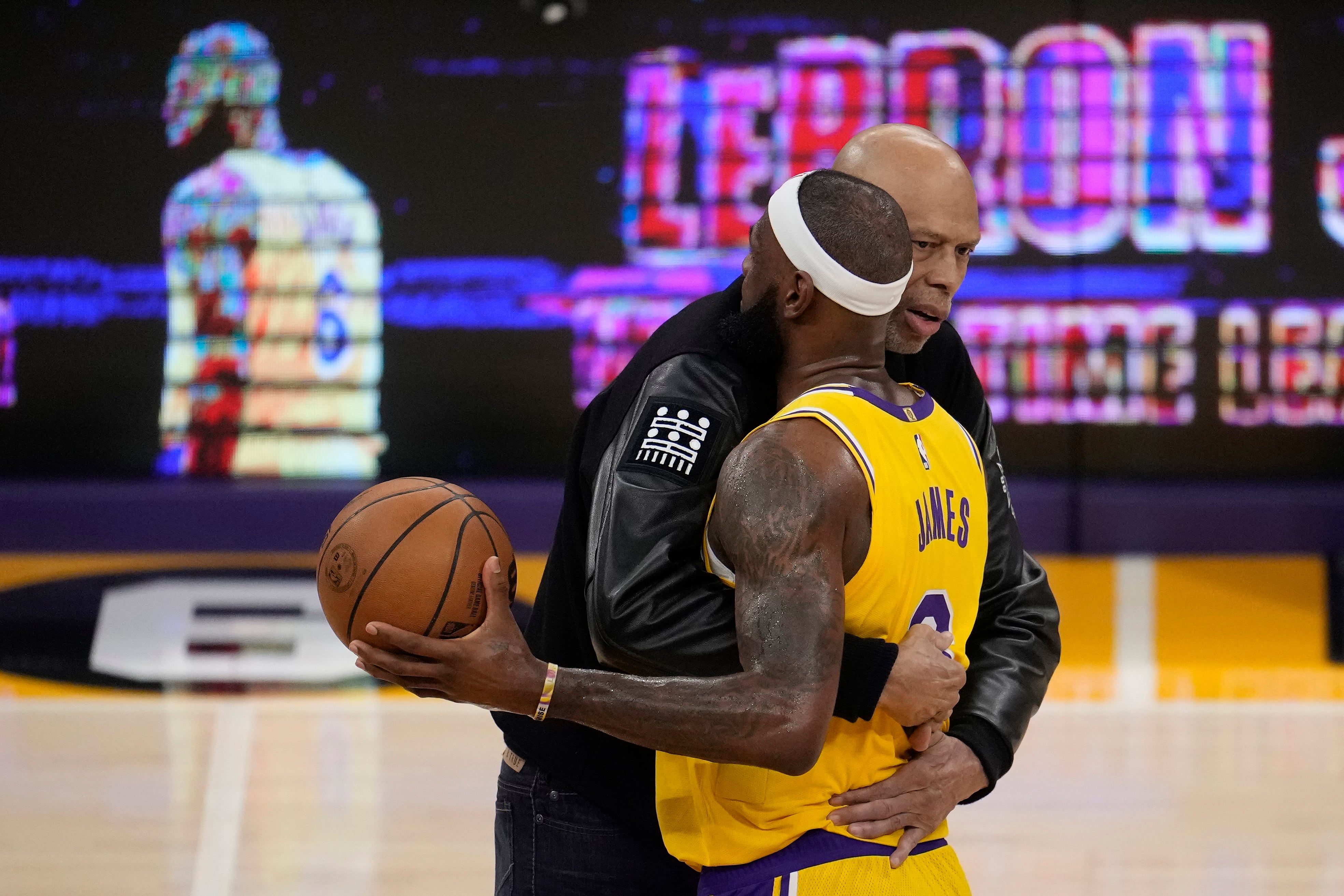 Kareem Abdul-Jabbar, left, hugs Los Angeles Lakers forward LeBron James after passing Abdul-Jabbar to become the NBA's all-time leading scorer during the second half of an NBA basketball game against the Oklahoma City Thunder Tuesday, Feb. 7, 2023, in Los Angeles. (AP Photo/Marcio Jose Sanchez)