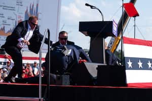 Republican presidential candidate former President Donald Trump is surrounded by U.S. Secret Service agents at a campaign rally, Saturday, July 13, 2024, in Butler, Pa. (AP Photo/Evan Vucci)
