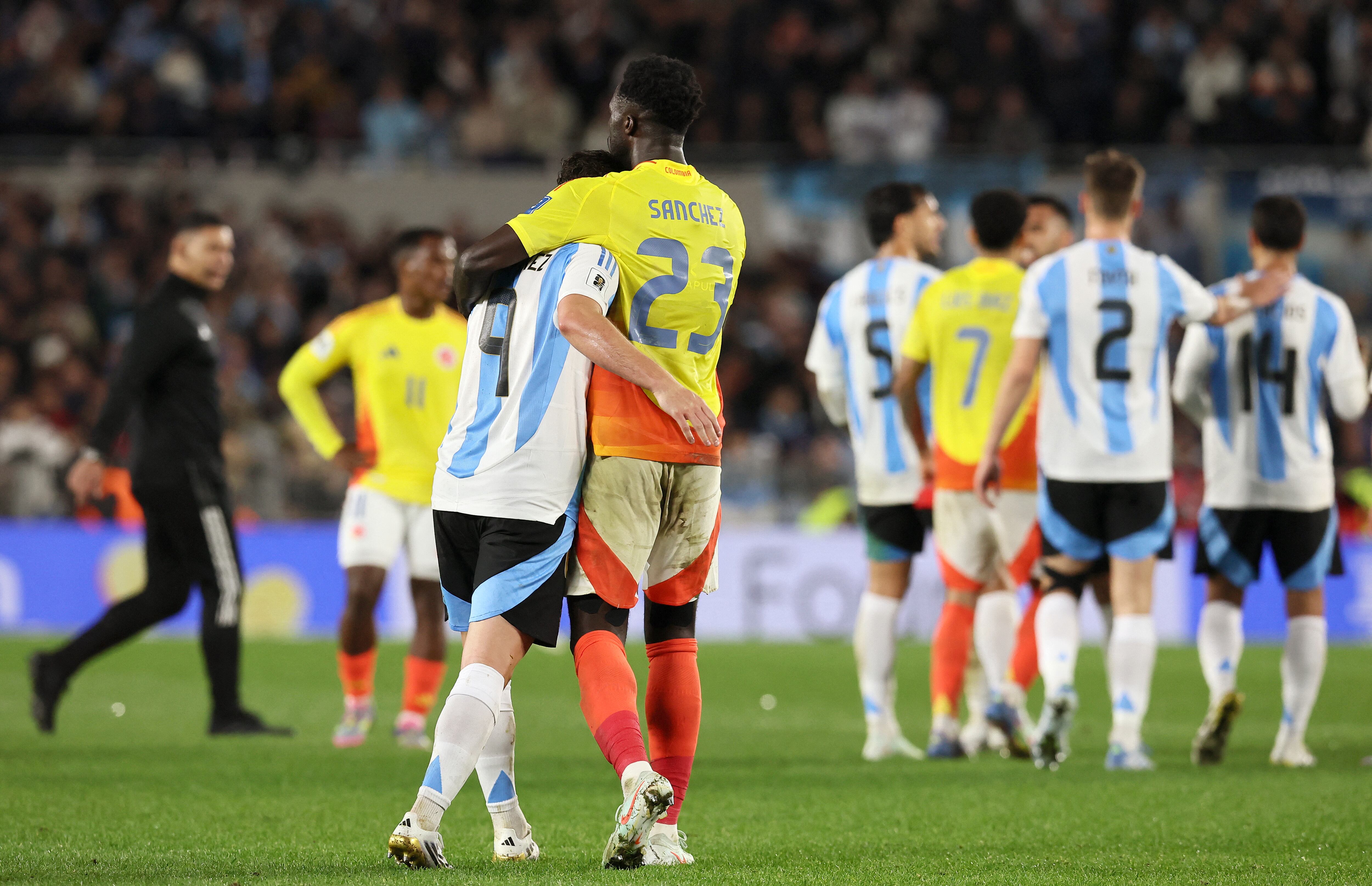 Argentina's forward #09 Julian Alvarez hugs Colombia's defender #23 Davinson Sanchez 
at the end of the 2026 FIFA World Cup South American qualifiers football match between Argentina and Colombia at the Mas Monumental stadium in Buenos Aires, on June 10, 2025. (Photo by ALEJANDRO PAGNI / AFP)