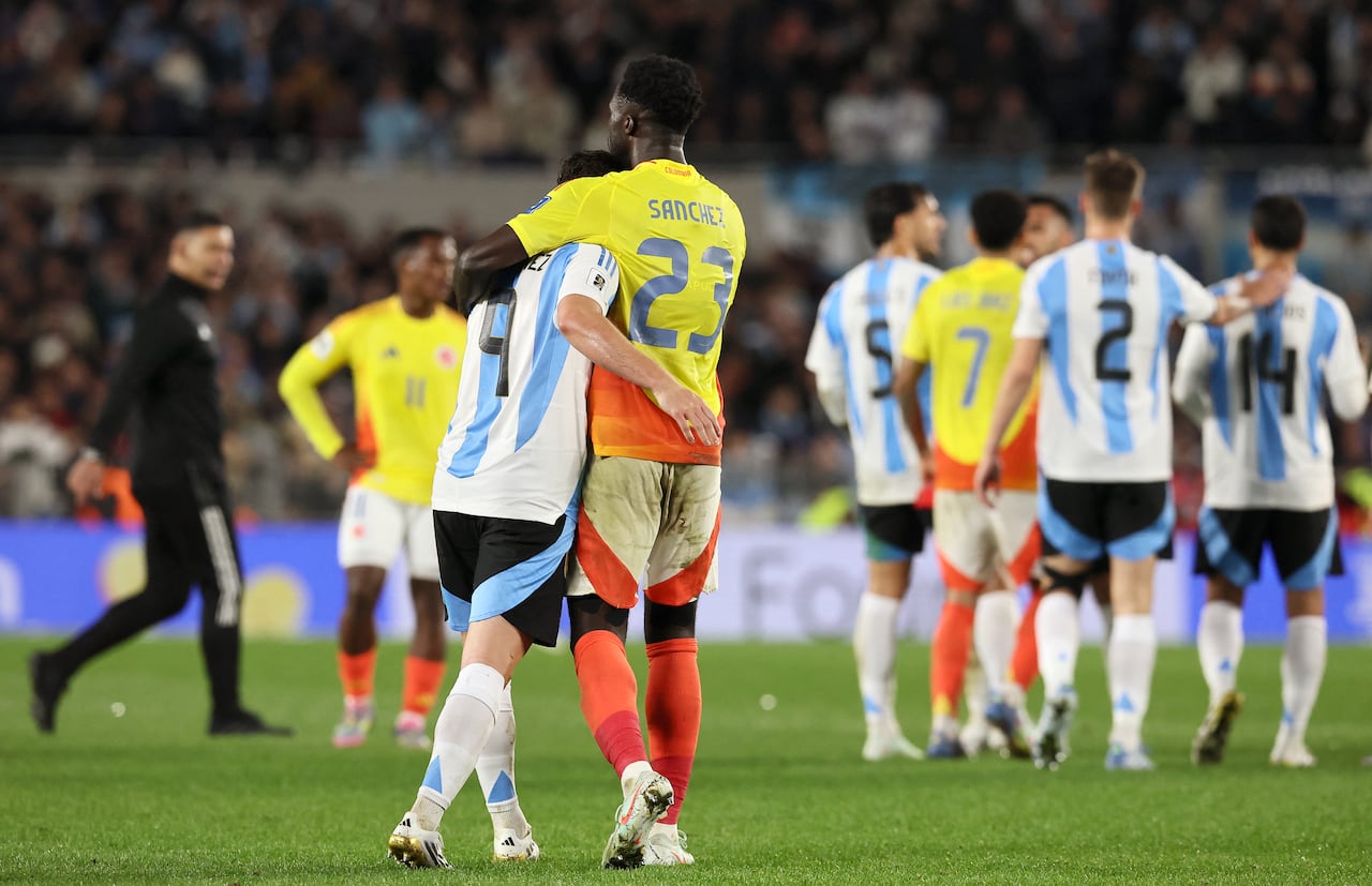 Argentina's forward #09 Julian Alvarez hugs Colombia's defender #23 Davinson Sanchez
at the end of the 2026 FIFA World Cup South American qualifiers football match between Argentina and Colombia at the Mas Monumental stadium in Buenos Aires, on June 10, 2025. (Photo by ALEJANDRO PAGNI / AFP)