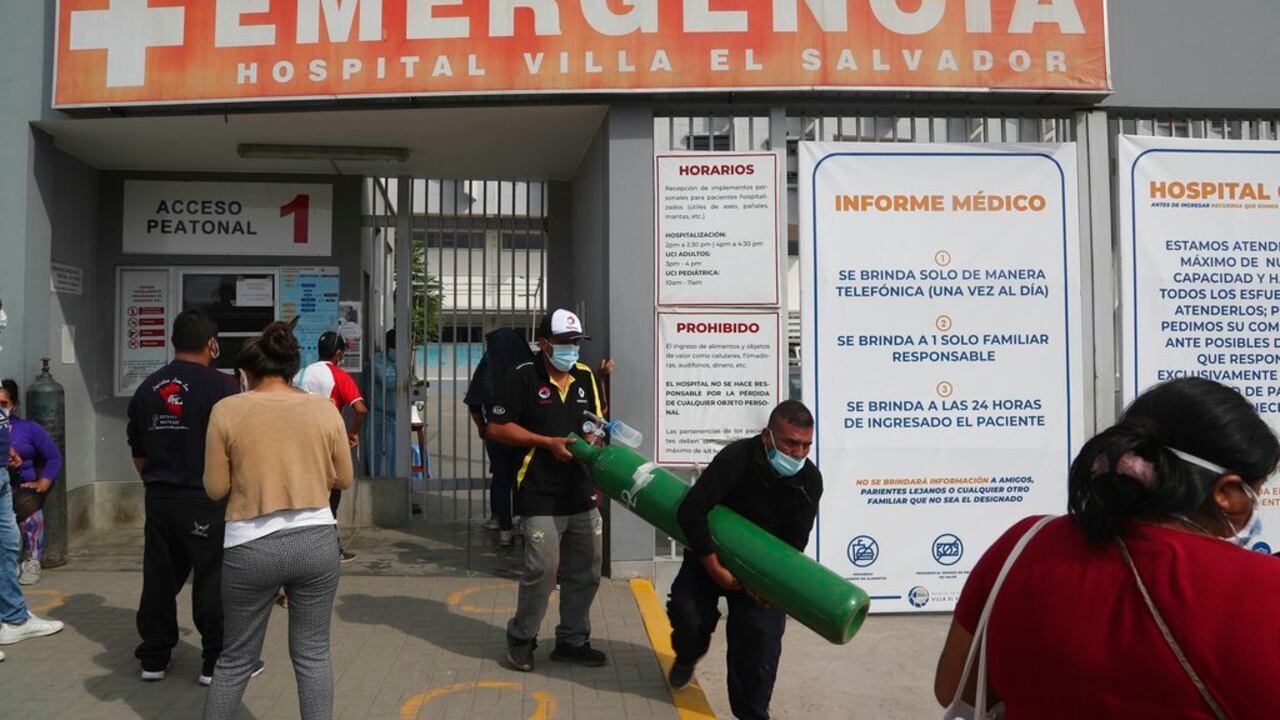 A man walks out of a hospital with an oxygen tank that needs to be filled, in the Villa El Salvador neighborhood in Lima, Saturday, Feb. 27, 2021, amid the new coronavirus pandemic. A crisis over the supply of medical oxygen for COVID-19 patients has struck nations in Africa and Latin America, where warnings went unheeded at the start of the pandemic and doctors say the shortage has led to unnecessary deaths. (AP Photo/Martin Mejia)