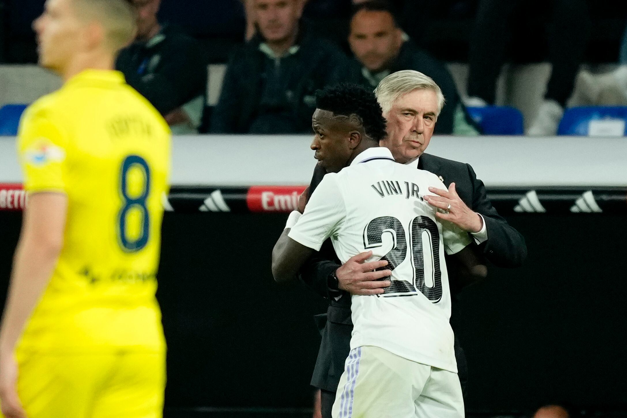 Real Madrid's Vinicius Junior celebrates with Real Madrid's head coach Carlo Ancelotti after scoring his side's second goal during a Spanish La Liga soccer match between Real Madrid and Villarreal at the Santiago Bernabeu stadium in Madrid, Saturday, April 8, 2023. (AP Photo/Jose Breton)