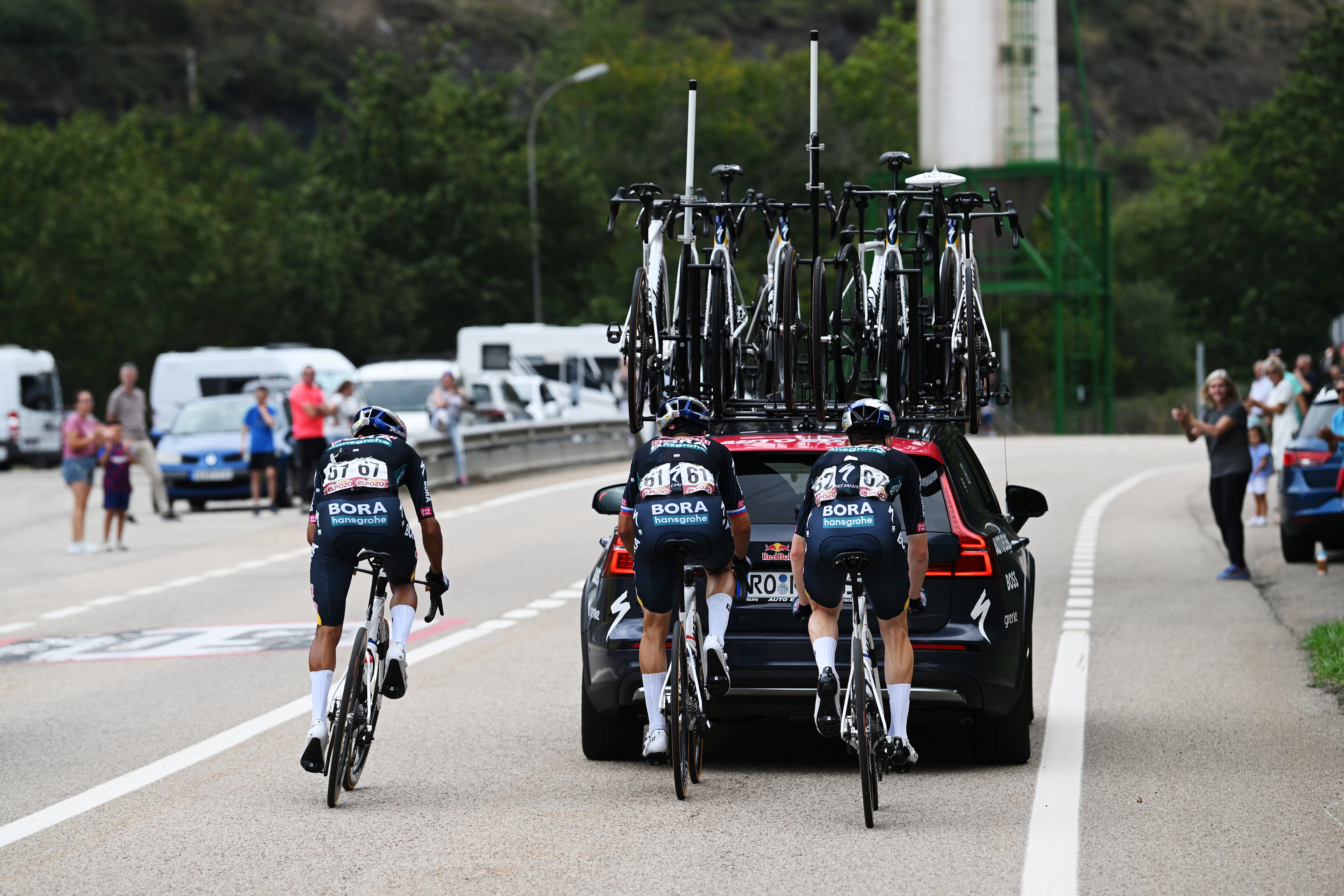 PAJARES, SPAIN - SEPTEMBER 01: (L-R) Daniel Martinez of Colombia, Primoz Roglic of Slovenia and Roger Adria of Spain and Team Red Bull Bora - hansgrohe assisted by the team car during the La Vuelta - 79th Tour of Spain 2024, Day 15 a 143km stage from Infiesto to Valgrande-Pajares. Cuitu Negru 1835m / #UCIWT / on September 01, 2024 in Pajares, Spain. (Photo by Dario Belingheri/Getty Images)