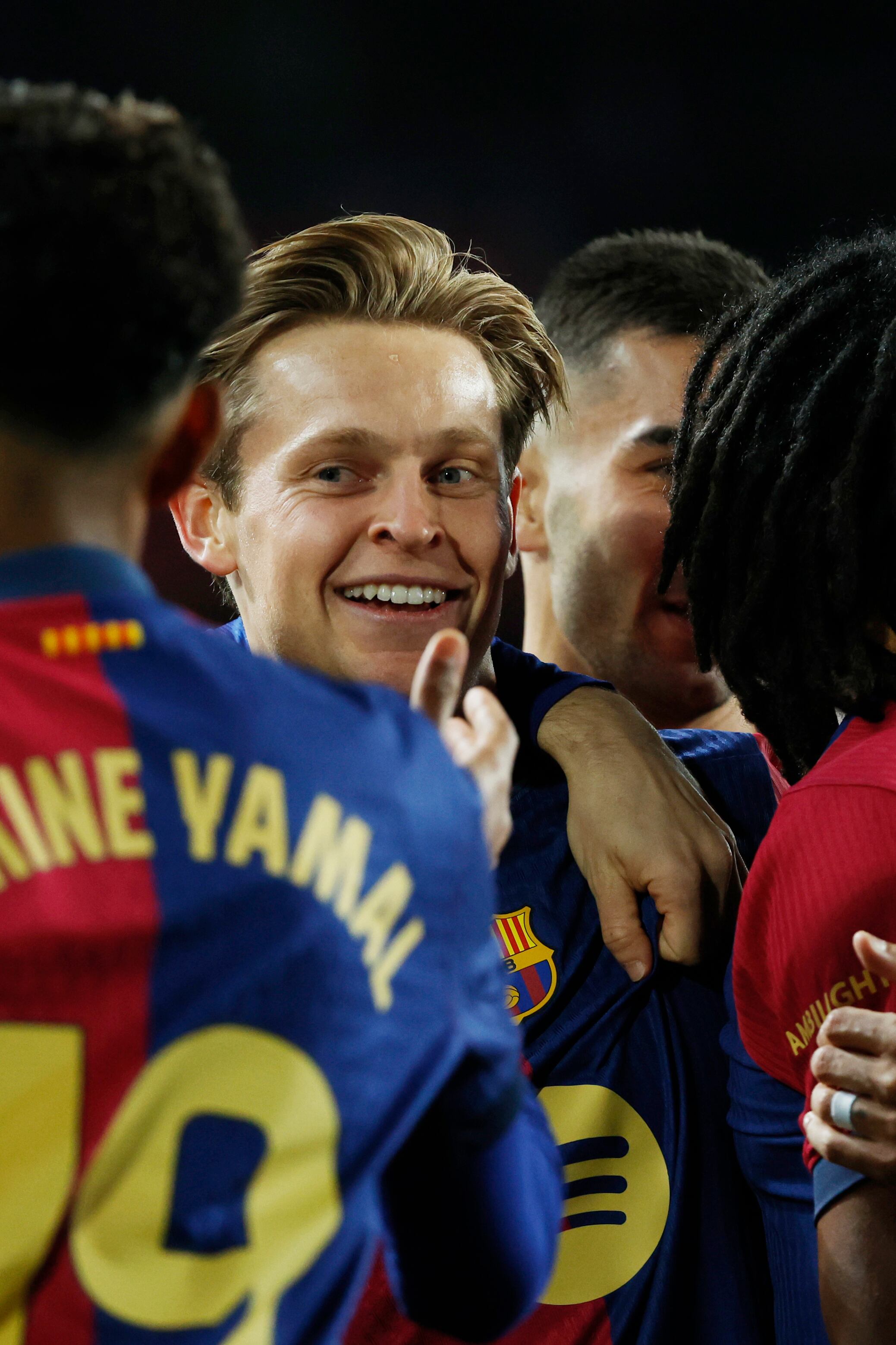 Barcelona's Frenkie de Jong, centre, celebrates with Fermin Lopez after scoring the opening goal during the Spanish La Liga soccer match between Barcelona and Valencia at the Lluis Companys Olympic Stadium in Barcelona, Spain, Sunday, Jan. 26, 2025. (AP Photo/Joan Monfort)