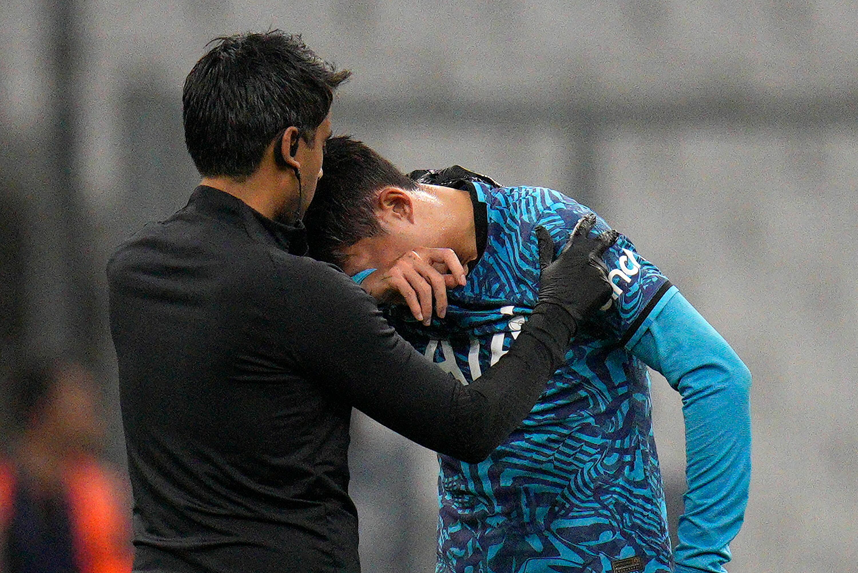 Tottenham's Son Heung-min receives treatment after taking a knock during the Champions League Group D soccer match between Marseille and Tottenham Hotspur at the Stade Velodrome in Marseille, France, Tuesday, Nov. 1, 2022. (AP Photo/Daniel Cole)