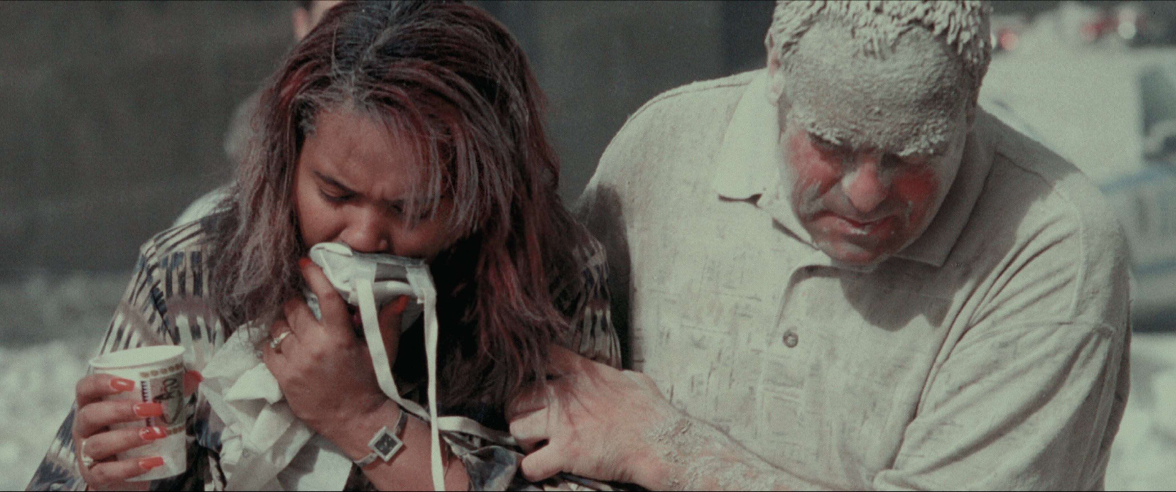 Turning Point: 9/11 and the War on Terror- Survivors of the attack covered in dust and debris from the fallen WTC towers from episode A PLACE OF DANGER, Season 1 of Turning Point: 9/11 and the War on Terror. Credit: Courtesy of NETFLIX / ©NETFLIX 2021