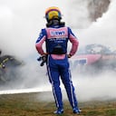 Alpine driver Fernando Alonso of Spain watches smoke pour from his car during a Formula One pre-season testing session at the Catalunya racetrack in Montmelo, just outside of Barcelona, Spain, Friday, Feb. 25, 2022. (AP Photo/Joan Monfort)