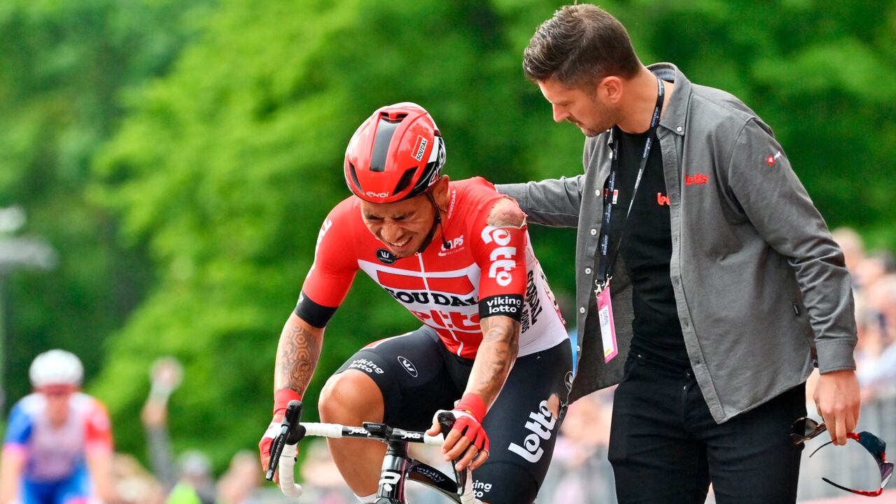Australia's Caleb Ewan is assisted as he approaches the finish line after falling down during the opening stage of the Giro d'Italia cycling race, from Budapest to Visegrad, Hungary, Friday, May 6, 2022. (Massimo Paolone/LaPresse via AP)