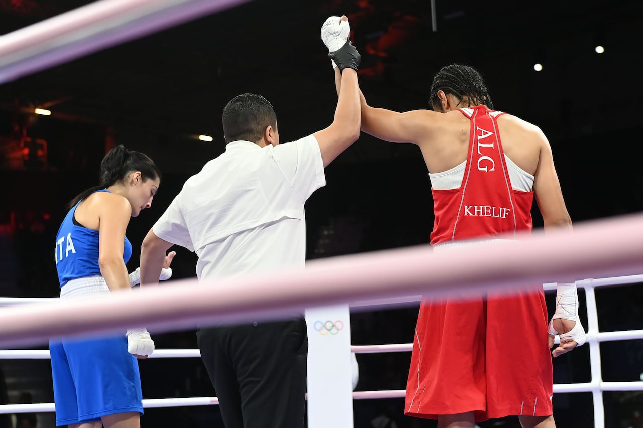 PARIS, FRANCE - AUGUST 1: Algeria's Imane Khelif (in red) during the Women's 66kg preliminary round match against Angela Carini of Italy (in blue) on day six of the Olympic Games Paris 2024 at North Paris Arena on August 01, 2024 in Paris, France. (Photo by Fabio Bozzani/Anadolu via Getty Images)