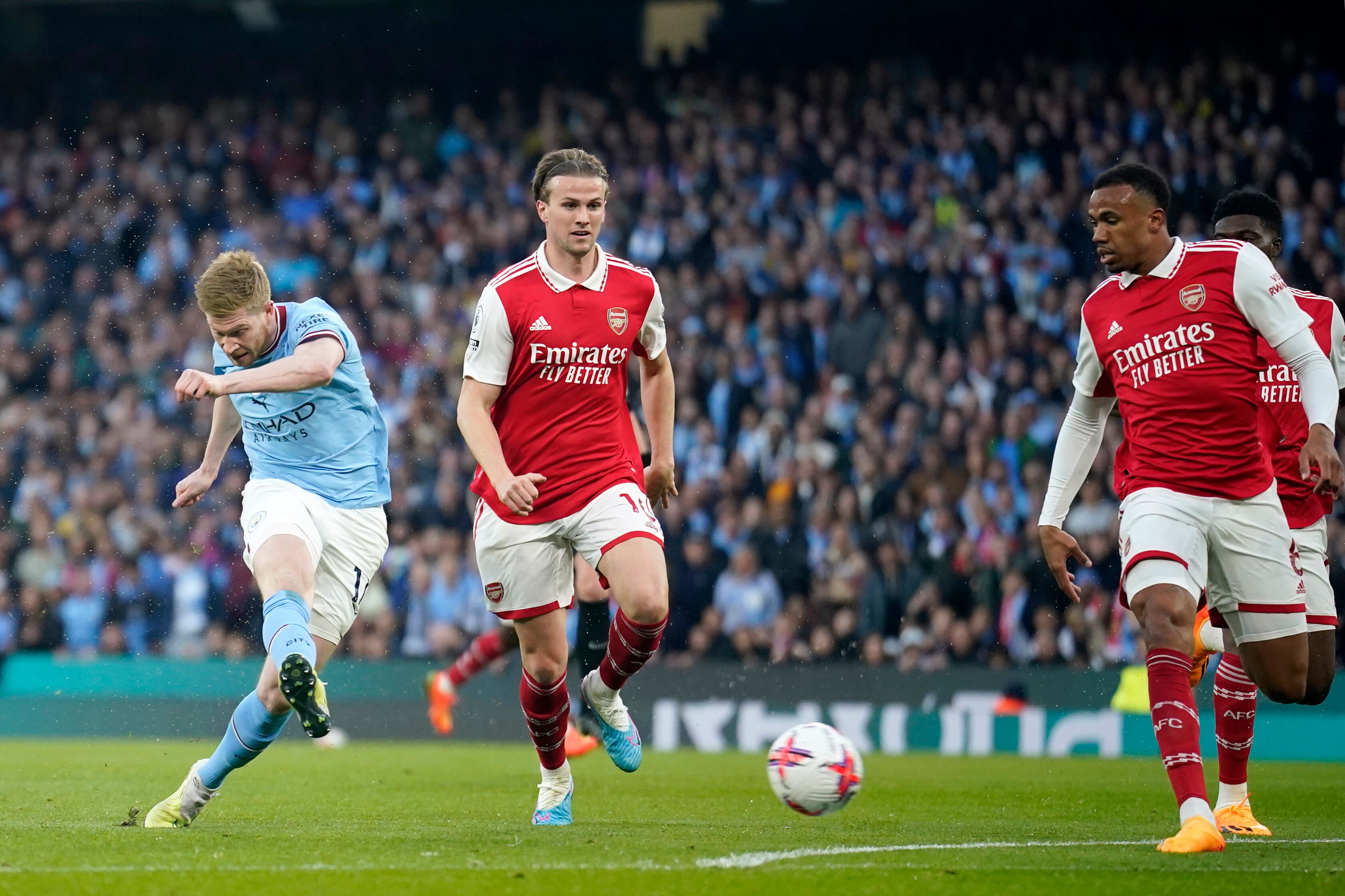 Manchester City's Kevin De Bruyne, left, scores the opening goal during the English Premier League soccer match between Manchester City and Arsenal at Etihad stadium in Manchester, England, Wednesday, April 26, 2023. (AP Photo/Dave Thompson)