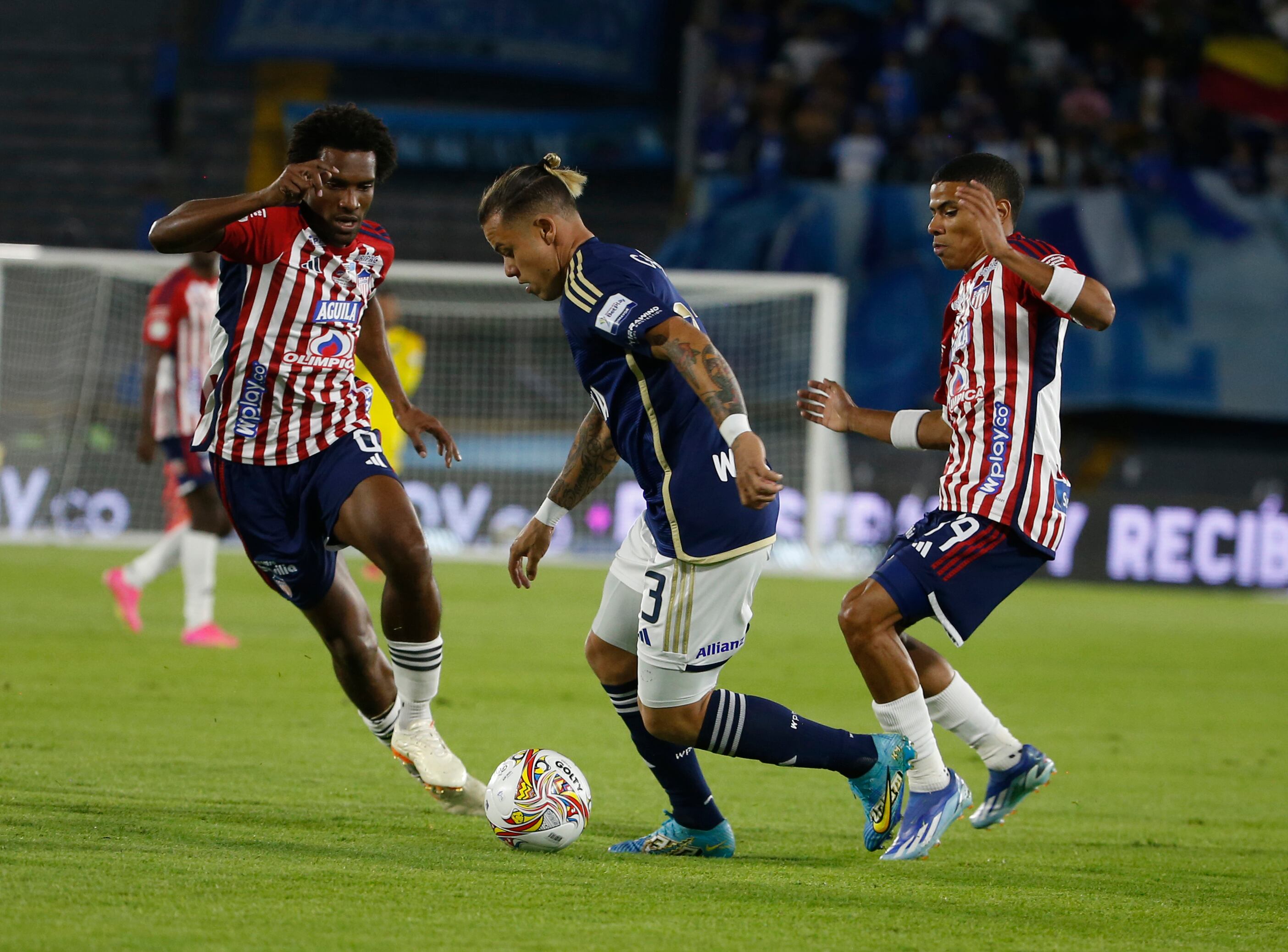 BOGOTA, COLOMBIA - JANUARY 24: Leonardo Castro (C) of Millonarios fights for the ball against Didier Moreno and Jose Enamorado of Junior during the Superliga Betplay final football match between Millonarios and Junior at El Campin stadium on January 24, 2024 in Bogota, Colombia. (Photo by John Vizcaino/VIEWpress)