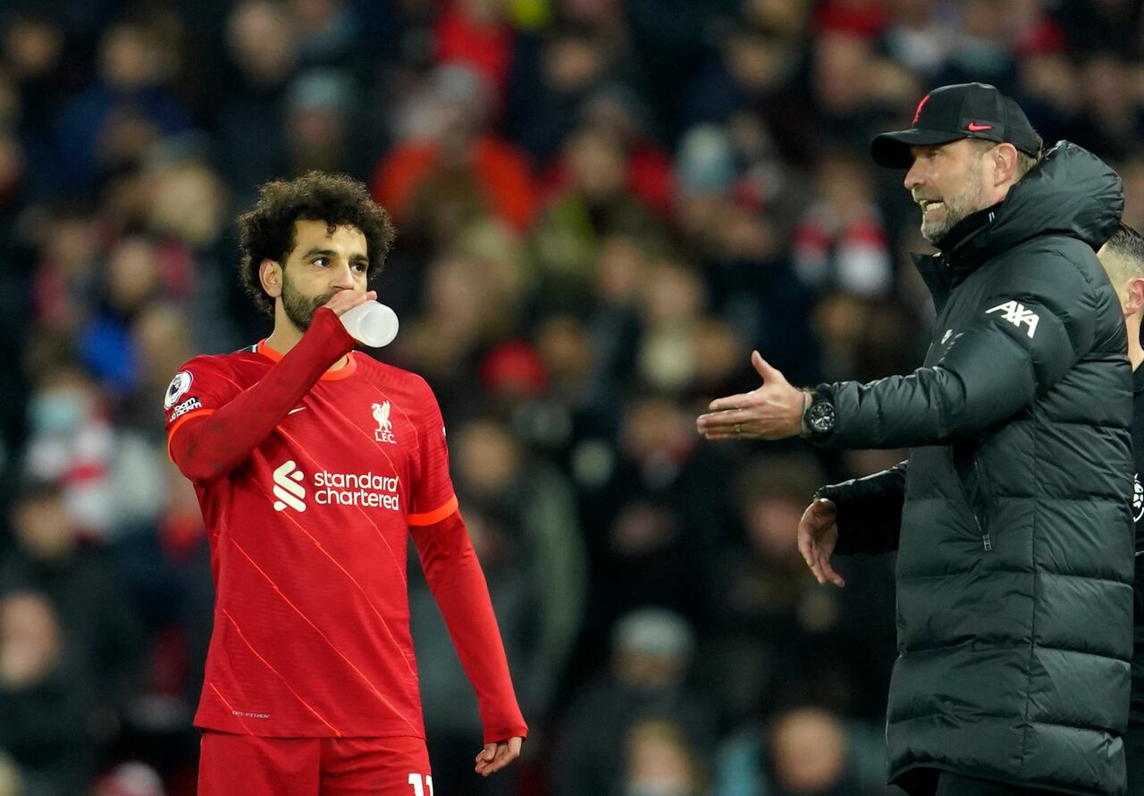 Liverpool's manager Jurgen Klopp, right, gives instructions to Liverpool's Mohamed Salah during the English Premier League soccer match between Liverpool and Newcastle United at Anfield stadium in Liverpool, England, Thursday, Dec. 16, 2021. (AP Photo/Jon Super)