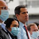 Flanked by party members, Venezuelan opposition leader Juan Guaido, center, stands during a press conference, a day after parliamentary elections, in Caracas, Venezuela, Monday, Dec. 7, 2020. Guaido rejected the results of Sunday's elections in which the government of President Nicolas Maduro declared victory in an election where the European Union said did not meet democratic standards and could not be considered credible. (AP Photo/Ariana Cubillos)