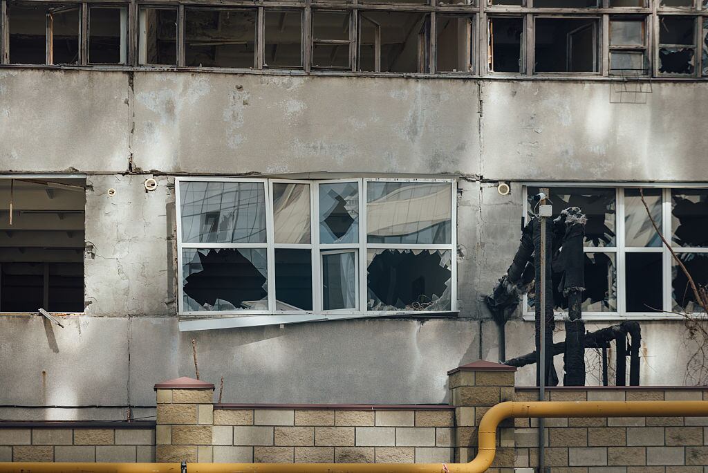 DNIPRO, UKRAINE - MARCH 27: Damaged windows and facades of the buildings around the impact site of Russian drone attack on March 27, 2025 in Dnipro, Ukraine. In Dnipro, three people were injured in a massive Russian drone attack on the evening of March 26. The shelling damaged businesses, educational and cultural institutions, and more than a dozen high-rise residential buildings. More than 60 cars were damaged, and several more were destroyed. On the morning of March 27, residents, workers of damaged buildings, and municipal services came out to overcome the consequences of the strikes. They remove debris, glass, and shattered furniture. Tow trucks remove fire-damaged cars. (Photo by Denys Poliakov/Global Images Ukraine via Getty Images)
