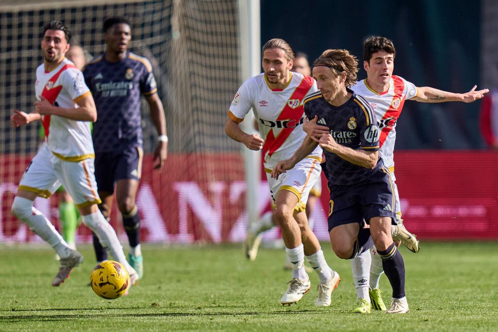 MADRID, SPAIN - FEBRUARY 18: Sergio Camello of Rayo Vallecano battle for the ball with Luka Modric of Real Madrid CF during the LaLiga EA Sports match between Rayo Vallecano and Real Madrid CF at Estadio de Vallecas on February 18, 2024 in Madrid, Spain. (Photo by Diego Souto/Getty Images)