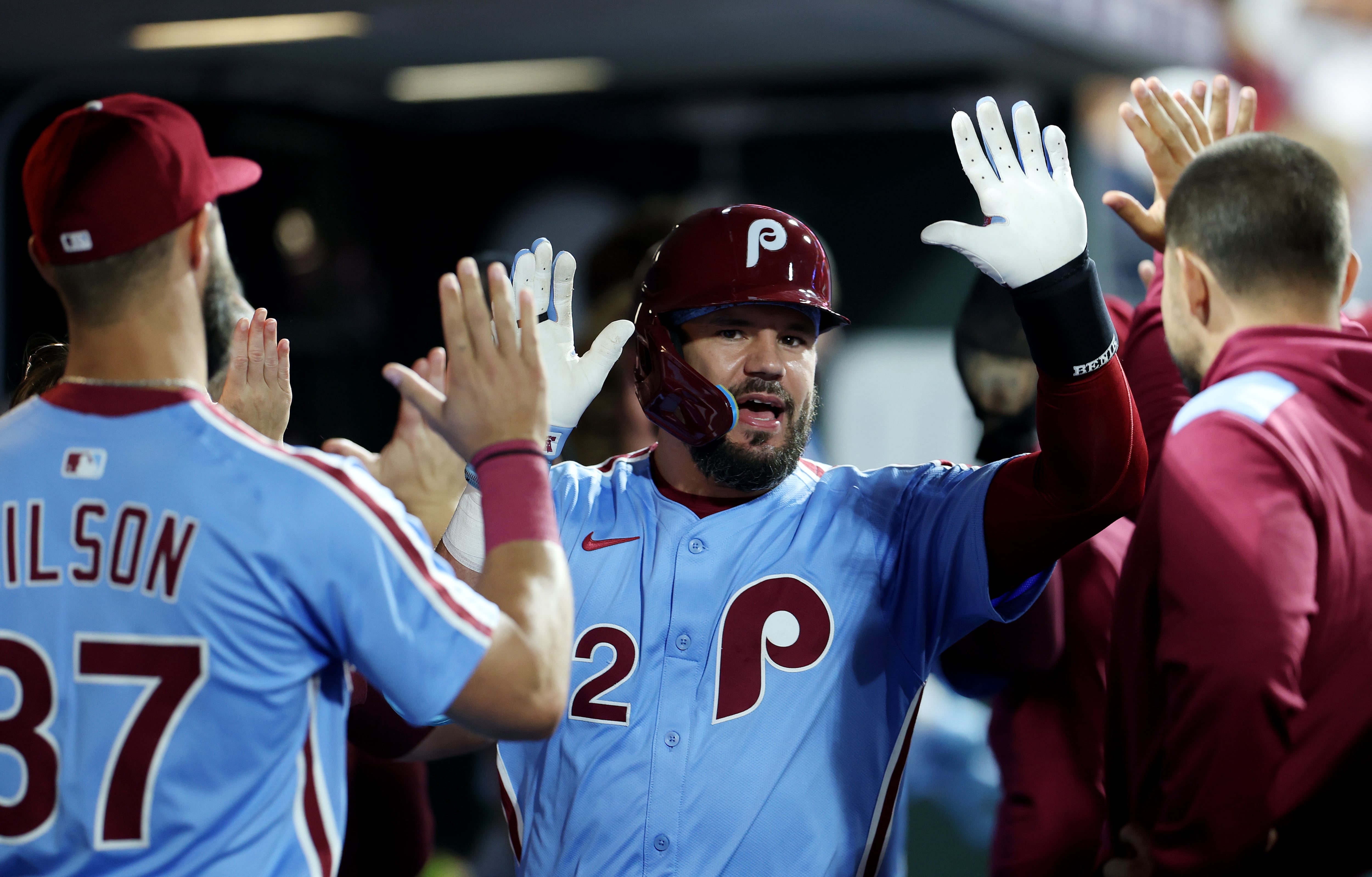 PHILADELPHIA, PENNSYLVANIA - AUGUST 28: Kyle Schwarber #12 of the Philadelphia Phillies celebrates in the dugout after hitting a two-run home run in the fourth inning against the Atlanta Braves at Citizens Bank Park on August 28, 2025 in Philadelphia, Pennsylvania. (Photo by Emilee Chinn/Getty Images)