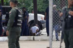 Inmates sit with their hands behind their backs during a raid of the Tocorón Penitentiary Center, in Tocorón, Venezuela, Wednesday, Sept. 20, 2023. Soldiers carried out the prison raid in an effort to dismantle one of the largest criminal gangs in the country, according to Interior Minister Admiral Remigio Ceballos. (AP Photo/Ariana Cubillos)