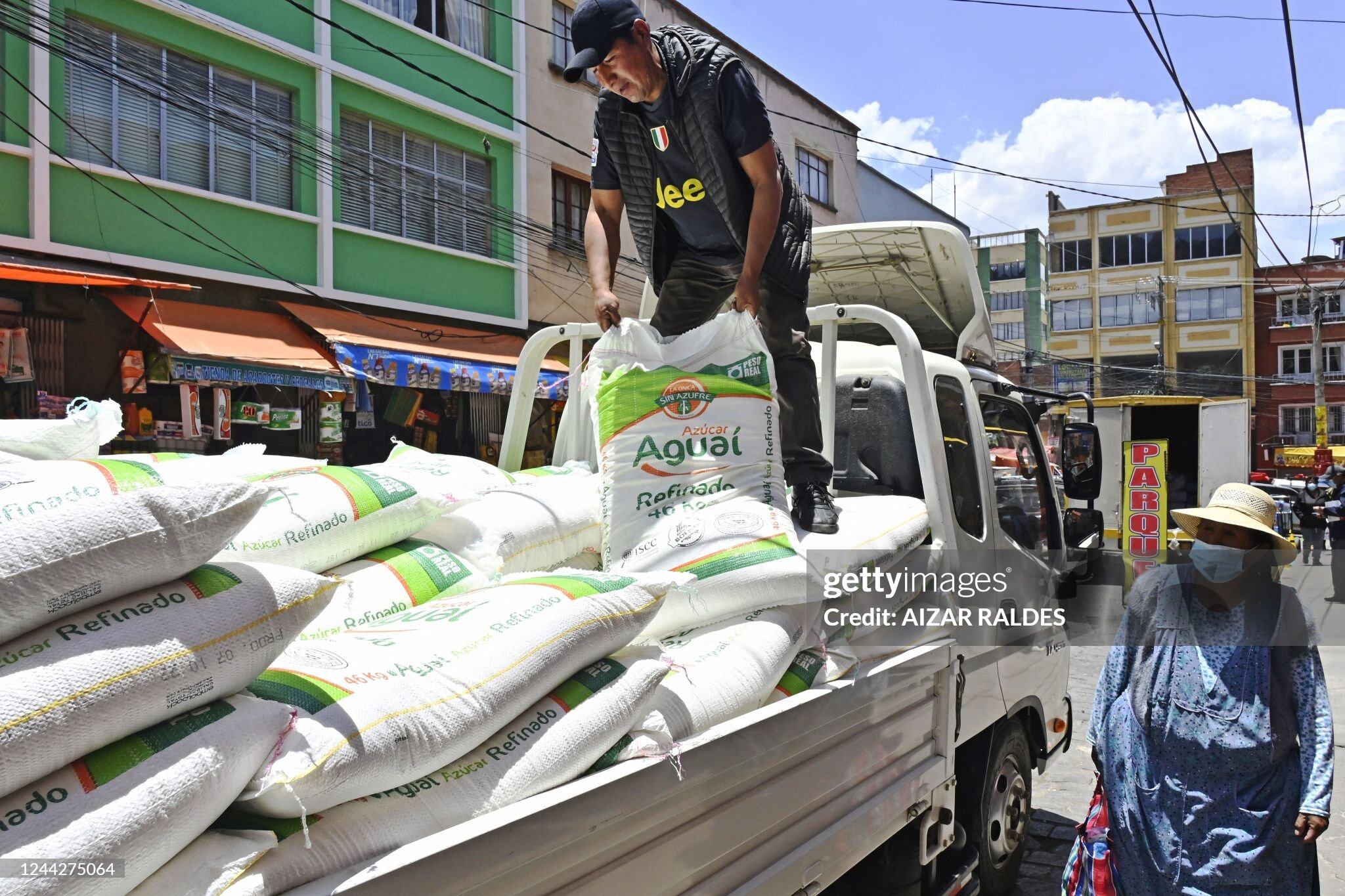A man unloads sugar bags from a truck at a market in La Paz, on October 27, 2022. - Bolivia has suspended several exports to avoid possible food shortages after strikes paralyzed the country's economic hub. Authorities decided to "temporarily suspend the export of soybean, soybean cake, soy flour, sugar, oil and beef" because "there is a risk of shortage" and price increases, productive development minister Nestor Huanca said in a press conference on Wednesday. (Photo by AIZAR RALDES / AFP) (Photo by AIZAR RALDES/AFP via Getty Images)