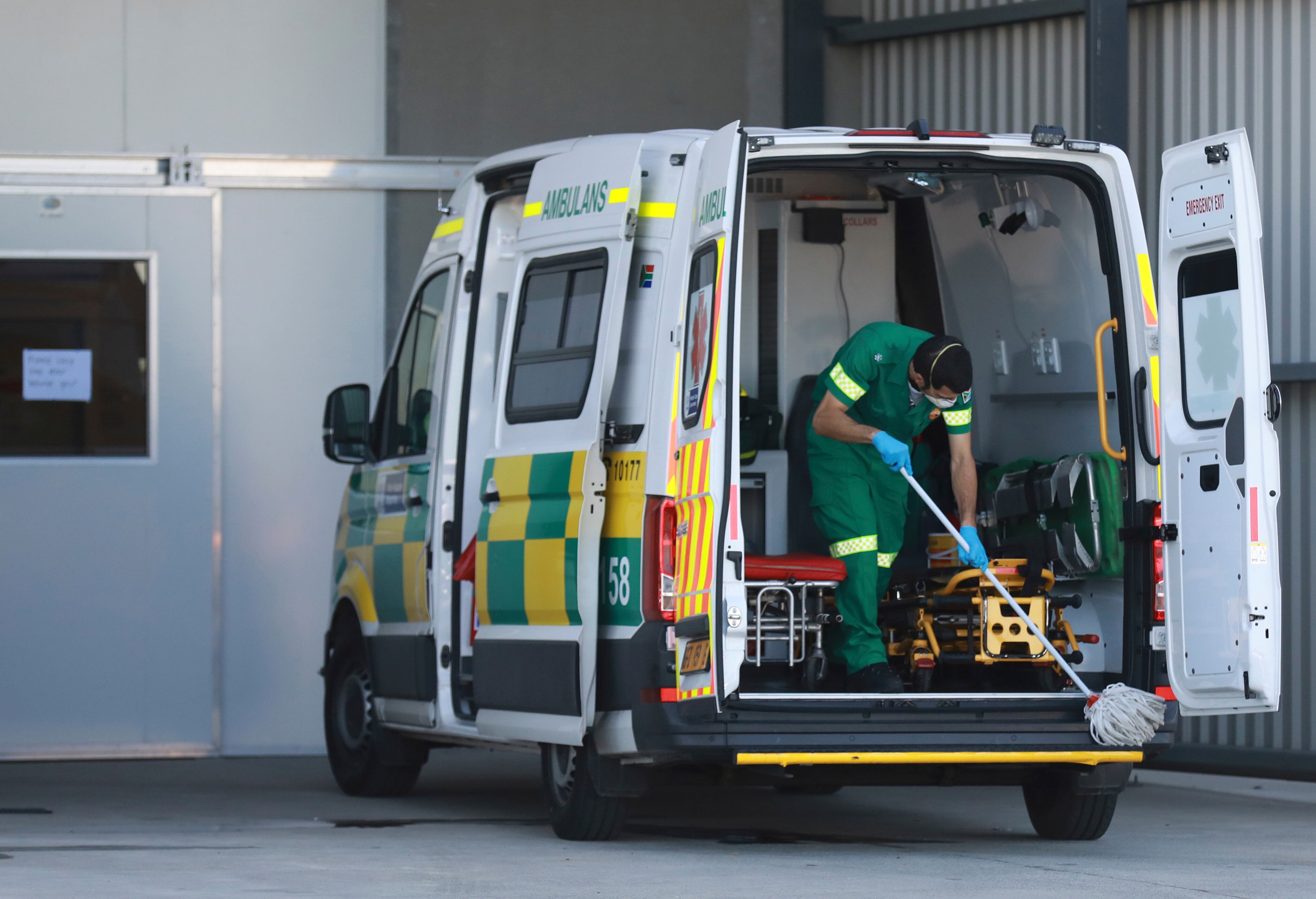 Un paramédico limpia una ambulancia después de dejar a un paciente de COVID en el Brackengate Hospital of Hope, en Ciudad del Cabo, Sudáfrica. (AP Photo / Nardus Engelbrecht)